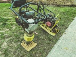 lawn mowing machine. huge lawnmower on oil and gasoline. hand tool for creating a smooth landscape. metal construction with buttons and holder photo