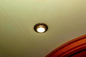 Ceiling lamp glows. Round surface of the lamp. Close-up photo. photo