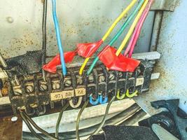 DIY electrical box. small cables, nails and wires in a box for connecting and distributing the electrical network in the house. homemade power line photo