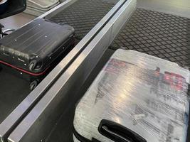 Suitcase on the airport luggage conveyor belt photo