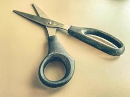 stationery on the table in the office. metal scissors with black handles. paper cutting, tool for work. scissors on a white matte background photo