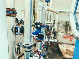 utility room. gray metal structures. on designs of blue valves with red switches. factory premises, water purification from pollution, harmful bacteria and microorganisms photo