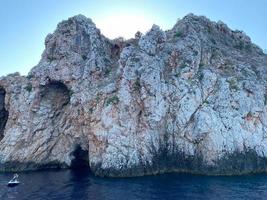 Rock Formations In Sea Against Sky photo