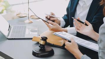 Justice and law concept.Male judge in a courtroom with the gavel, working with, computer and docking keyboard, eyeglasses, on table in morning light video