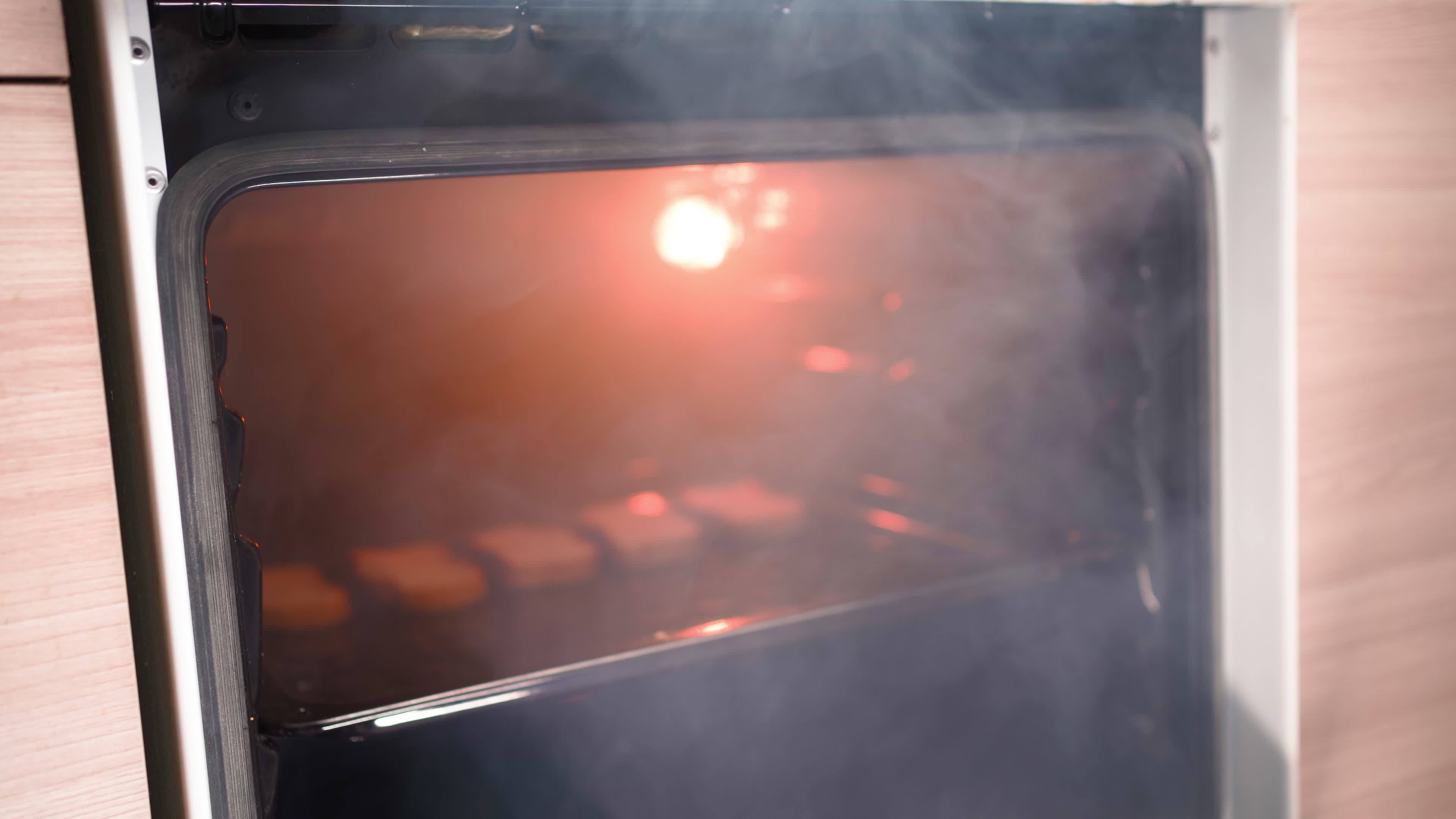Unrecognizable Man Opens an Oven Full of Smoke in the Kitchen. Male
