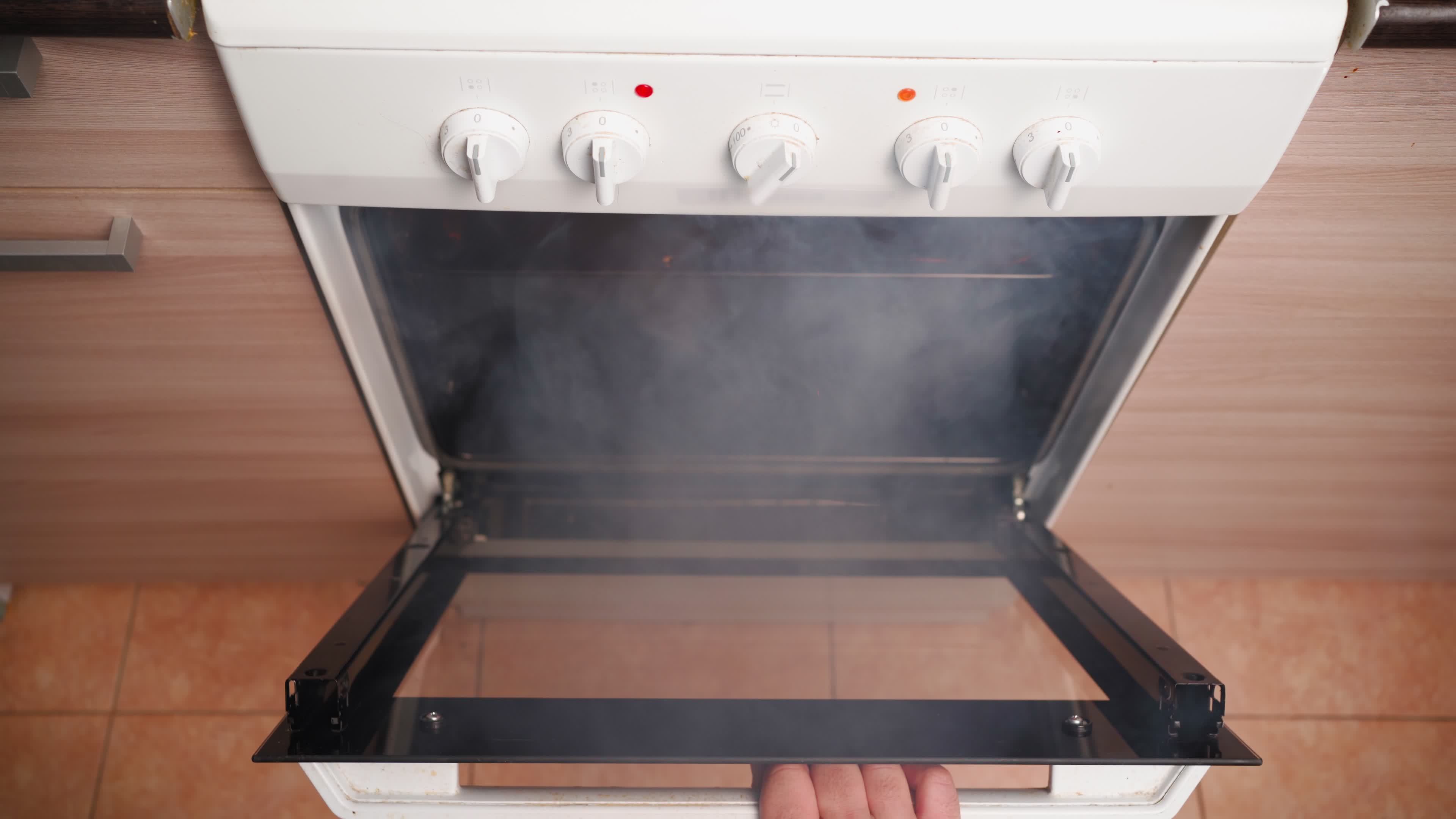 Unrecognizable Man Opens an Oven Full of Smoke in the Kitchen. Male