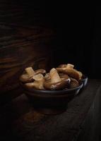 Delicious pickled mushrooms in a beautiful clay cup . photo