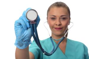 young female doctor holding stethoscope. isolated. photo