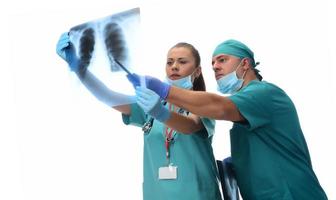 Female radiologists and male doctor checking patient xray. Isolated on white background photo