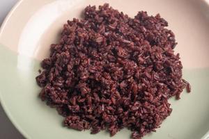 Cooked Riceberry in Plate on White Background photo