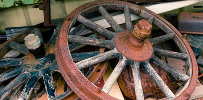 Wooden spoked wheels laying in a pile photo