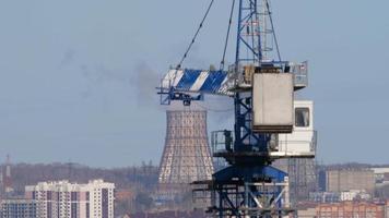 Tower crane on the industrial background. video