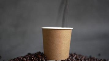 Pour coffee beans into a brown paper cup. video