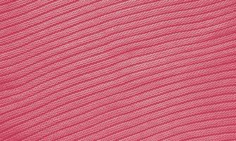 Texture of smooth knitted sweater with pattern. Handmade knitting wool or cotton fabric texture. Background of Large knit pattern with knitting needle or crochet. Color Of The Year 2023 - Viva Magenta photo