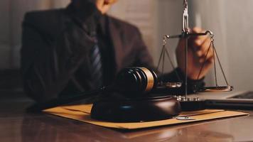 justice and law concept.Male judge in a courtroom on wooden table and Counselor or Male lawyer working in office. Legal law, advice and justice concept. video