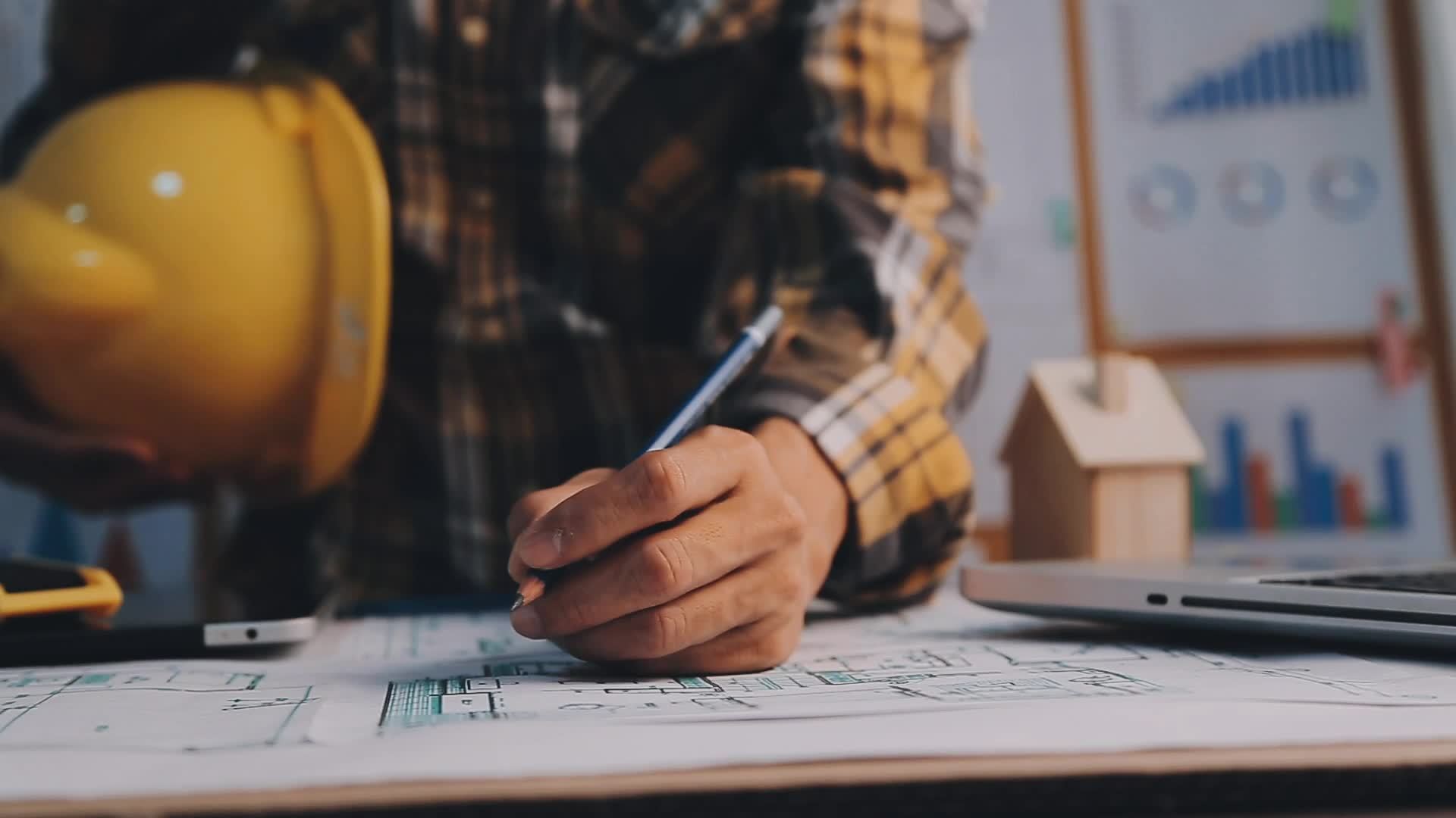 Construction engineer working at blueprint to build large commercial