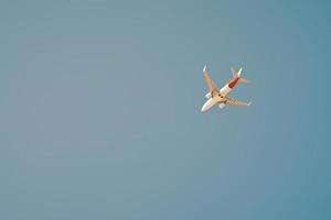 Airplane in blue sky, toned photo