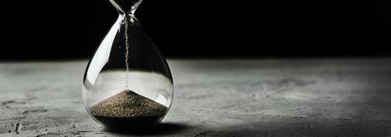 Hourglass on a dark background, long banner photo