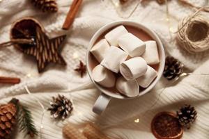 Cup of hot chocolate with marshmallow and christmas decorations photo
