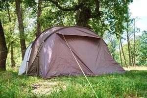 Campimg tent in pine forest in a summer day. Tourist camp photo