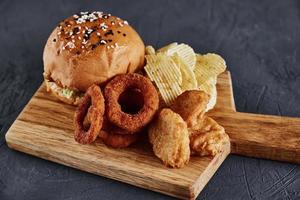 Unhealthy and junk food. Different types of fast food on the table, closeup photo