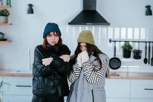 Warmly dressed women are upset with the heating turned off photo