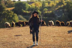 Female shepherd and flock of sheep at a lawn photo