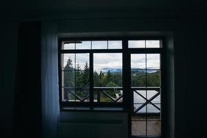 View of the mountain forest through the window photo