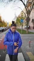 Front view of beautiful woman is jogging outdoor autumn day. photo