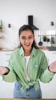 Young female clapping her hands filled with white flour at the kitchen photo