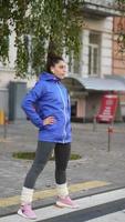 Fitness woman warming up before jogging outdoors photo