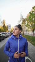 Beautiful adult woman is jogging outdoor on city street autumn day. photo