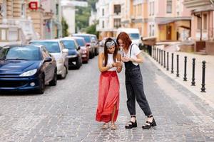 two young women walking outdoor having fun photo