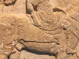 texture, clay sculpture made of plastic material. on the texture of scuffs, chips, cracks. voluminous material, ancient rock paintings with people and animals photo