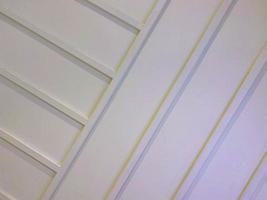 plastic white ceiling in the building. tiles made of artificial soft material for covering walls and ceilings. finishing materials for rooms photo