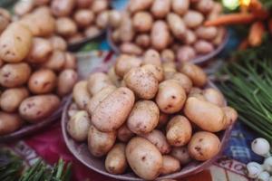 Closeup of potatoes on counter of farm market for sale.