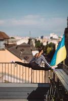 A young woman is doing twine on the roof of the house photo