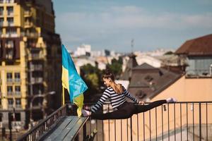 A young woman is doing twine on the roof of the house photo