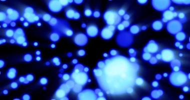 Beautiful festive bokeh effect, blue circles of light shining falling falling glowing christmas new year on black background. Abstract background. Screensaver photo