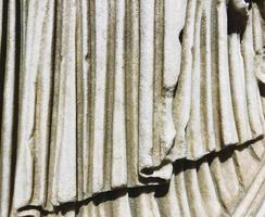 ancient texture. beige stone, voluminous background. a statue in robes, a piece of marble cloth. background is white. 3d coating, marble waves photo