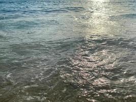 Waves, splashes of water on the beach at the sea on vacation in a tourist warm eastern tropical country southern paradise resort on vacation. The background photo