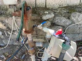 Homemade pump station in a pond for watering the garden photo