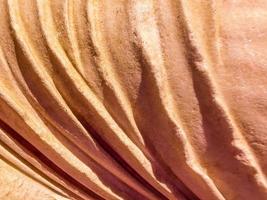 ancient texture. a stone of beige color, a piece of a statue. volumetric texture of stone and sand. 3d background, statue element. a piece of stone cloth photo