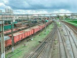 railroad in the city. metal rails. on the road are freight, freight wagons of red color, large and capacious wagons for the transport of goods photo