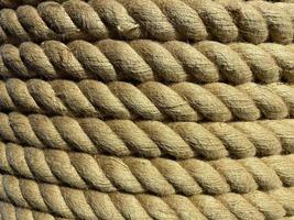 Background twisted rope. Rope texture. Brown and yellow rope texture. Old vintage sailboat rope photo