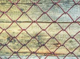 texture, background. natural, processed wood. the texture of the logs, the trees are behind a metal mesh. farm fence photo