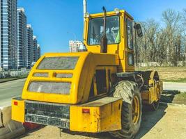 construction equipment yellow. excavator for construction, sand transfer. houses are being built in the city center, workers are erecting structures photo