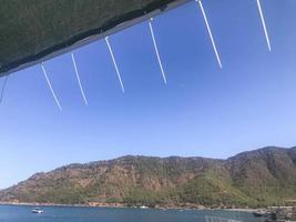 yacht tour. the top of the yacht is sheathed with a net from the wind. roof covering made of thin threads. mountain view from greenery and bushes photo