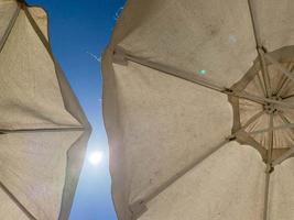 Low Angle View Of White Umbrella Against Sky photo