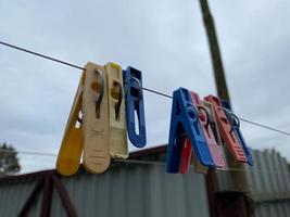 Multicolored clothespins on a clothesline for drying clothes, selective focus photo